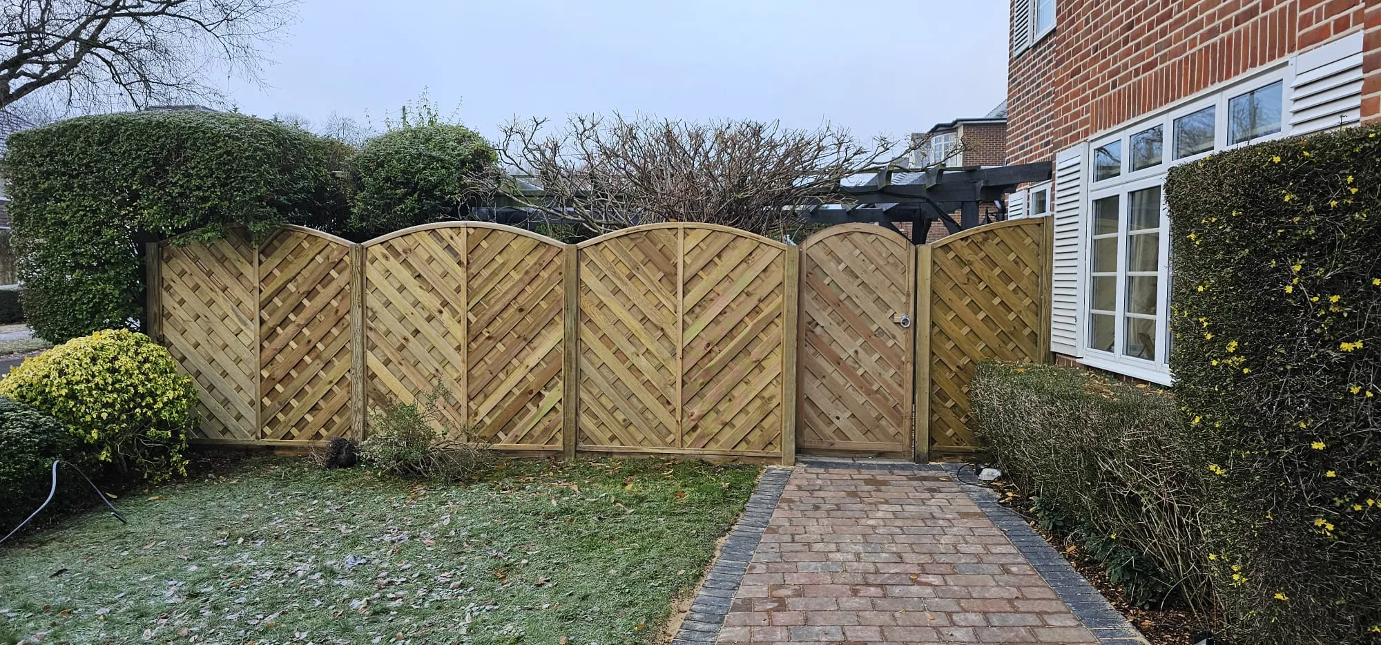 Patios 2 An image showing new horizontal design fence panels installed along with a gate to match the style.